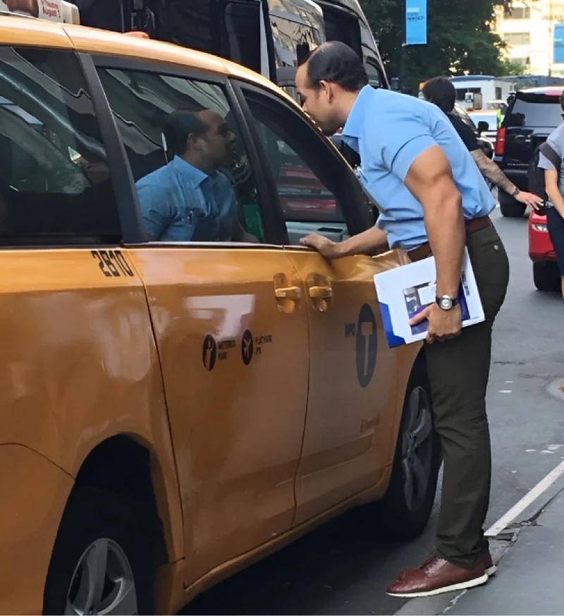 our founder next to a cab talking about ualett to get our first customer